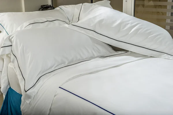 Comfortable soft  pillows situated  on the bed.