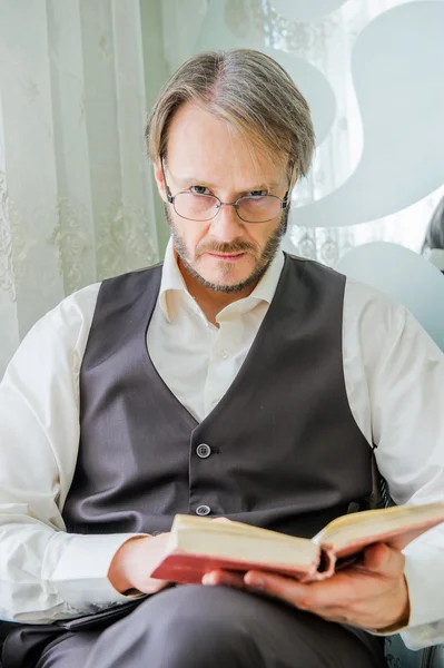 Portrait of reading man in interior,