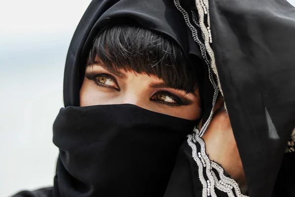 Beautiful arabic woman posing on sunset background.