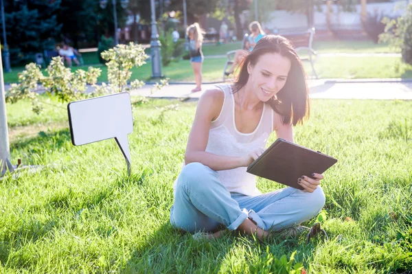 Yang and beautiful  woman poses outdoor with tablet computer.
