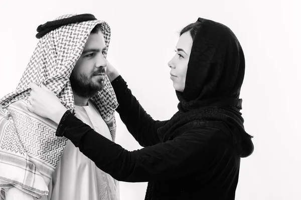 Half body of arabic couple posing together isolated on grey background.
