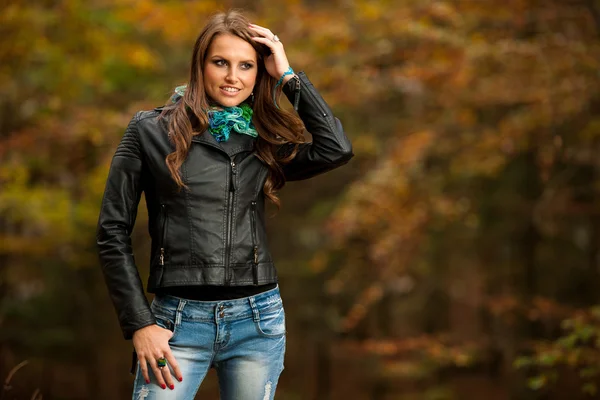 Blog style pretty young woman on a walk in forest on late autumn