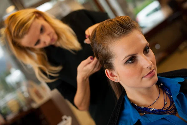 Young woman in hairdresser saloon having a treatment and haircut