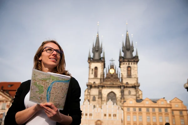 Beautiful young tourist woman photographing sites in Prague Czec