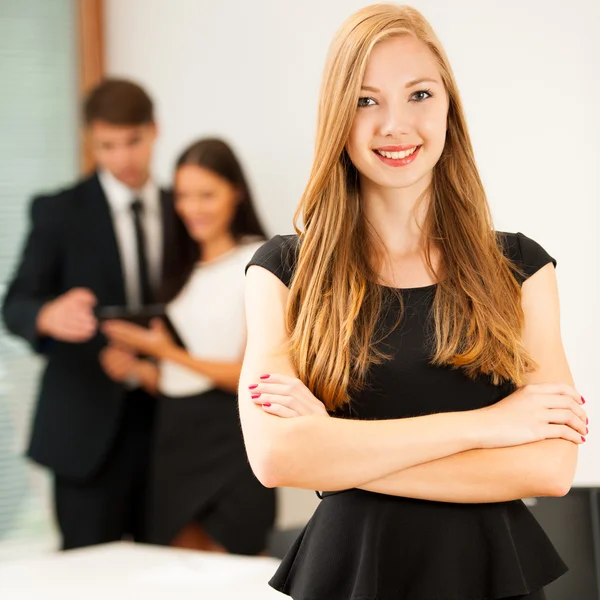 Business woman - secretarry  standing in first plain with cowork
