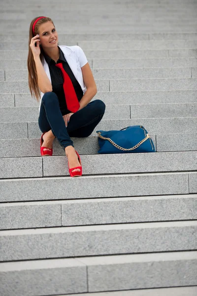 Blog style fashionable woman on stairs posing