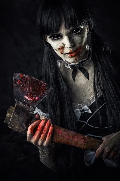 Dead female zombie with bloody axe