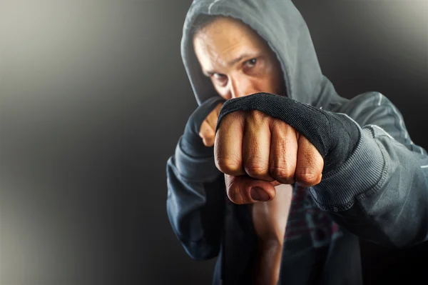 Fist of young dangerous man closeup