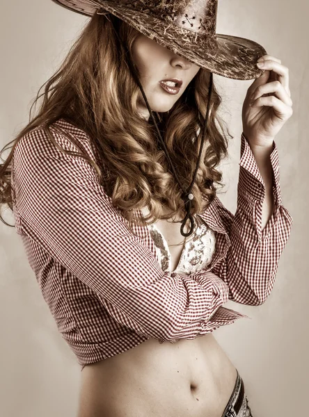 Beautiful cowgirl style woman wearing cowboy hat