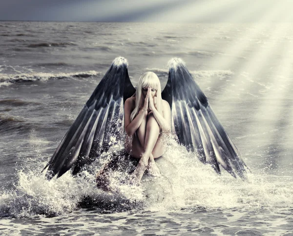 Woman with dark angel wings