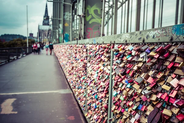 COLOGNE, GERMANY - AUGUST 26, 2014, Thousands of love locks which sweethearts lock to the Hohenzollern Bridge to symbolize their love on August 26 in Koln, Germany