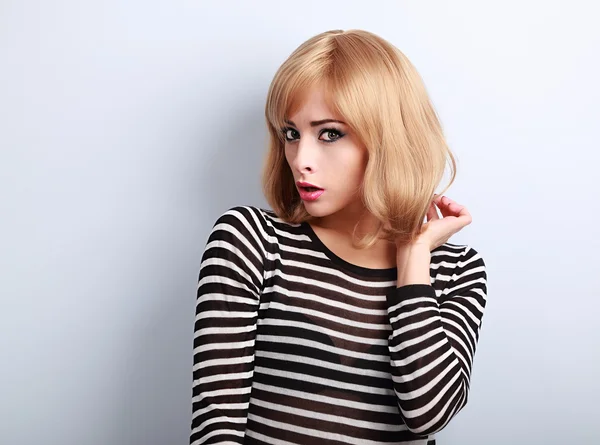 Unhappy surprising blond woman with short hairstyle looking with