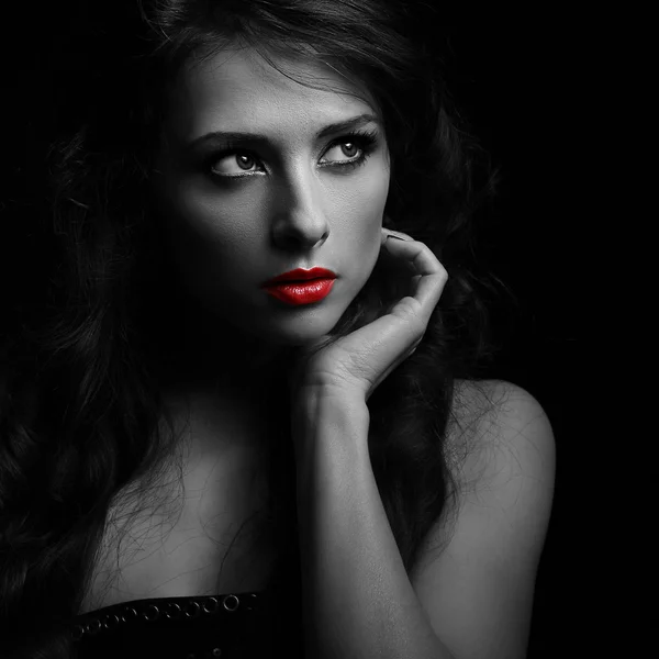 Beautiful makeup woman looking dramatic with red lipstick. Black and white portrait