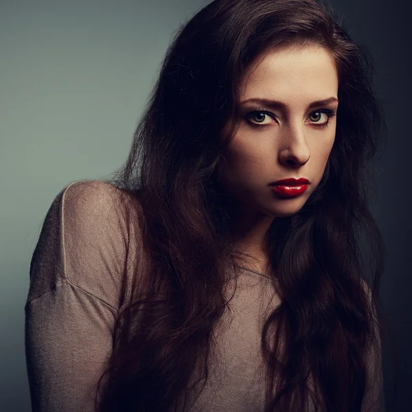 Sexy female makeup model looking dramatic with red lipstick. Vintage