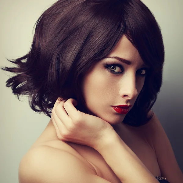 Beautiful makeup model with short black haircut and vamp look