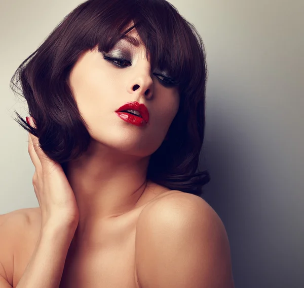 Sexy model posing with black short hairstyle and red lipstick