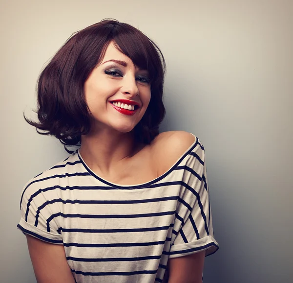 Happy laughing young woman with short hair in fashion blouse. Vi