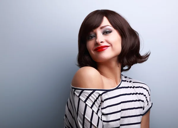 Beautiful smiling short hair woman looking happy on blue backgro