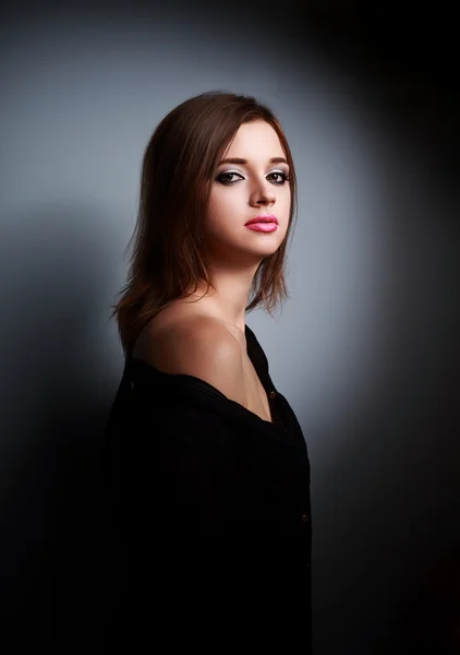 Beautiful makeup woman with calm emotions in black shirt on dark