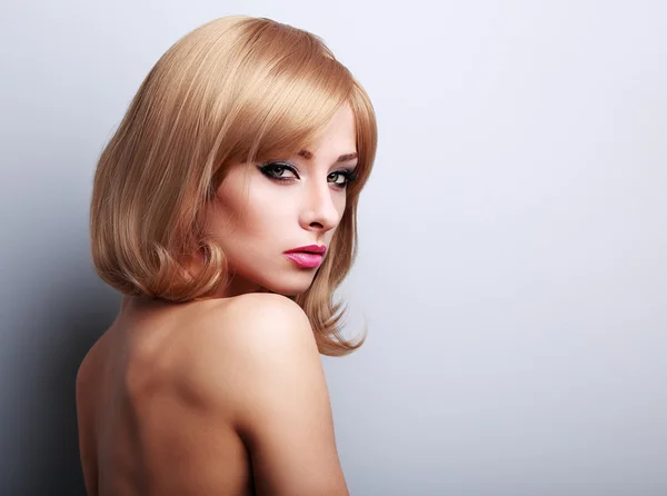 Glamour makeup female model with blond short hairstyle looking s