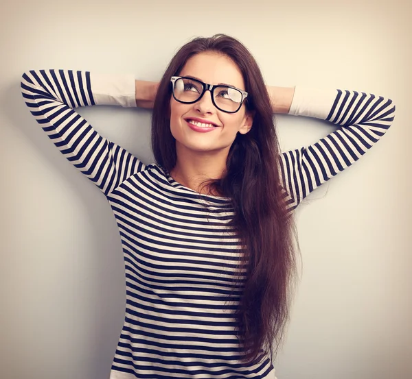 Beautiful relaxing woman in glasses looking up with thinking loo