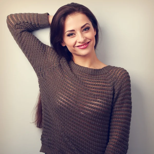 Happy emotional casual brunette woman smiling in warm sweater. V