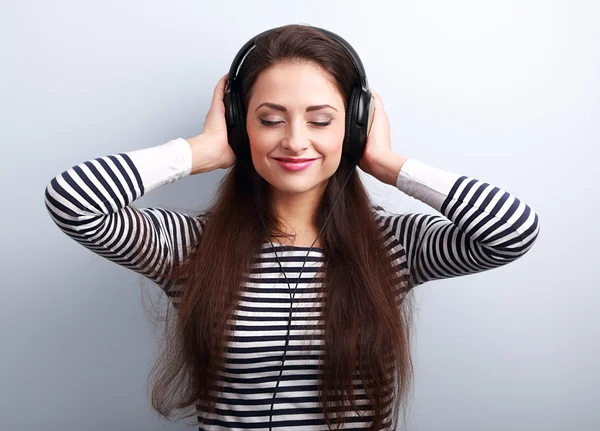 Happy relaxed woman with closed eyes listening the music in head