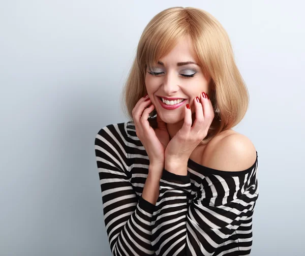 Happy natural laughing blond woman holding makeup face with clos