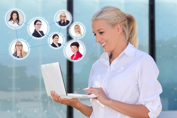 Social network concept - business woman with laptop in the stree