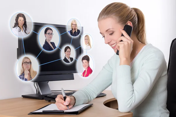 Social network concept - businesswoman talking on the phone in o