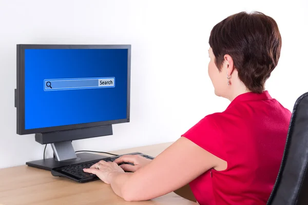 Business woman searching something in internet using pc