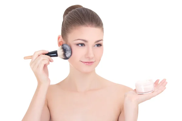 Portrait of young beautiful woman applying powder with make up b