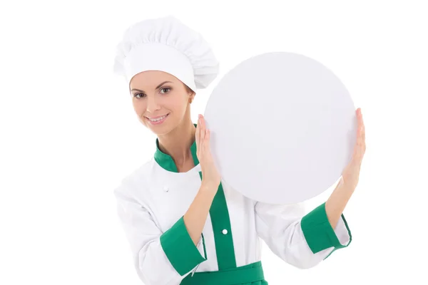 Chef woman in uniform holding big  empty plate with copy space i