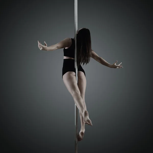 Pole dancer, young woman dancing on pylon