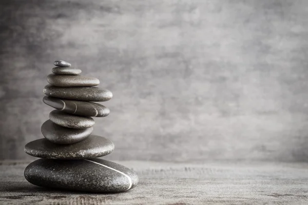 Balancing stones on the grey background.