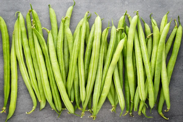 Green beans  on a gray background.