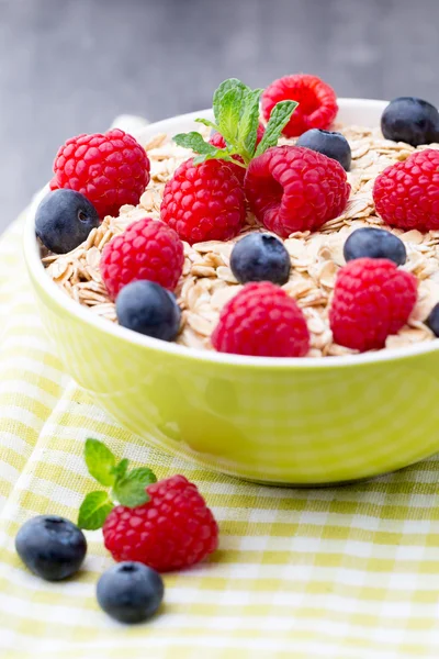 Oatmeal porridge with berries. Raspberries and blueberries.