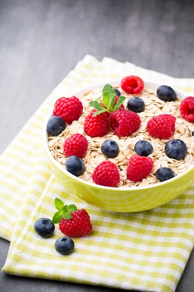 Oatmeal porridge with berries. Raspberries and blueberries.