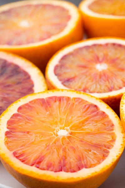 Mixed citrus fruit figs, limes on a gray background.