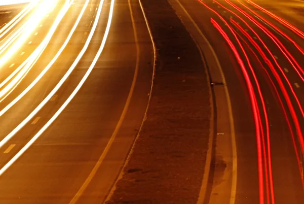 Speed Traffic at Dramatic Sundown Time - light trails on motorway highway at night, long exposure abstract urban background