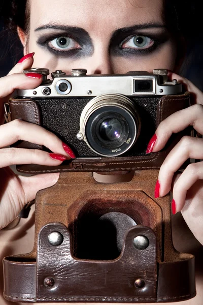 Young beautiful girl with a vintage camera