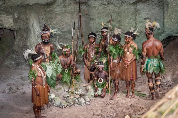 Papuans with bones and skulls.