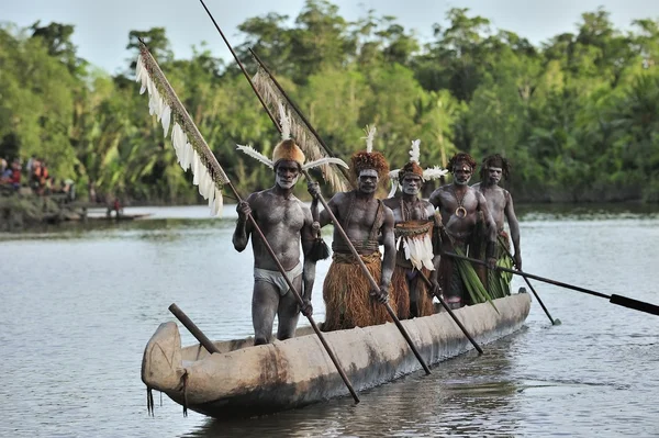 Canoe war ceremony of Asmat people. Headhunters of a tribe of Asmat . New Guinea Island, Indonesia. June 28 2012