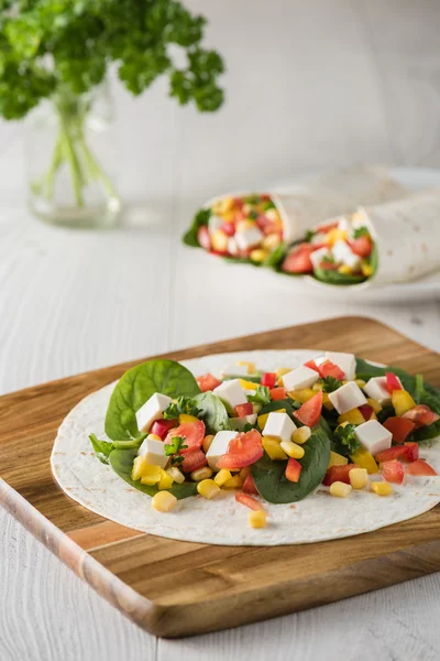 Vegan tofu wraps with pepper, corn, tomatoes and spinach