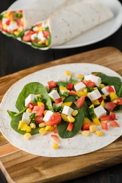 Vegan tofu wraps with pepper, corn, tomatoes and spinach