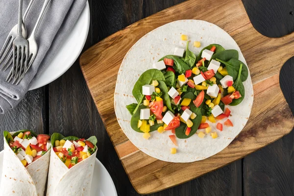 Vegan tofu wraps with pepper, corn, tomatoes and spinach