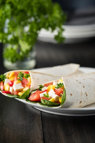 Vegan tofu wraps with pepper, corn, tomatoes and spinach