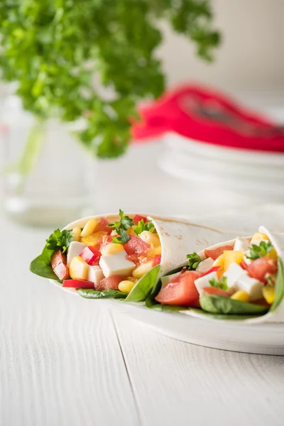 Vegan tofu wraps with pepper, corn, tomatoes and spinach