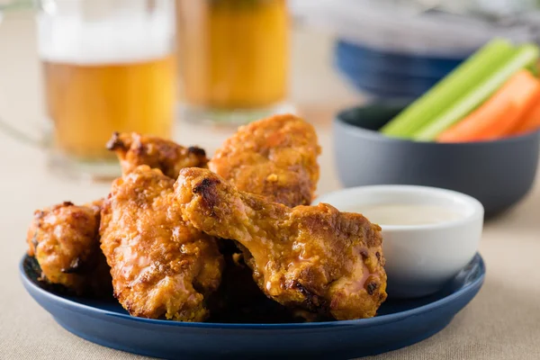 Barbecue hot chicken wings with beers at pub garden