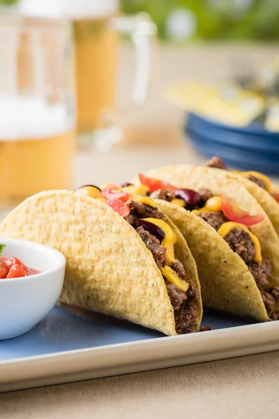 Mexican tacos with beef, cheddar cheese, tomato